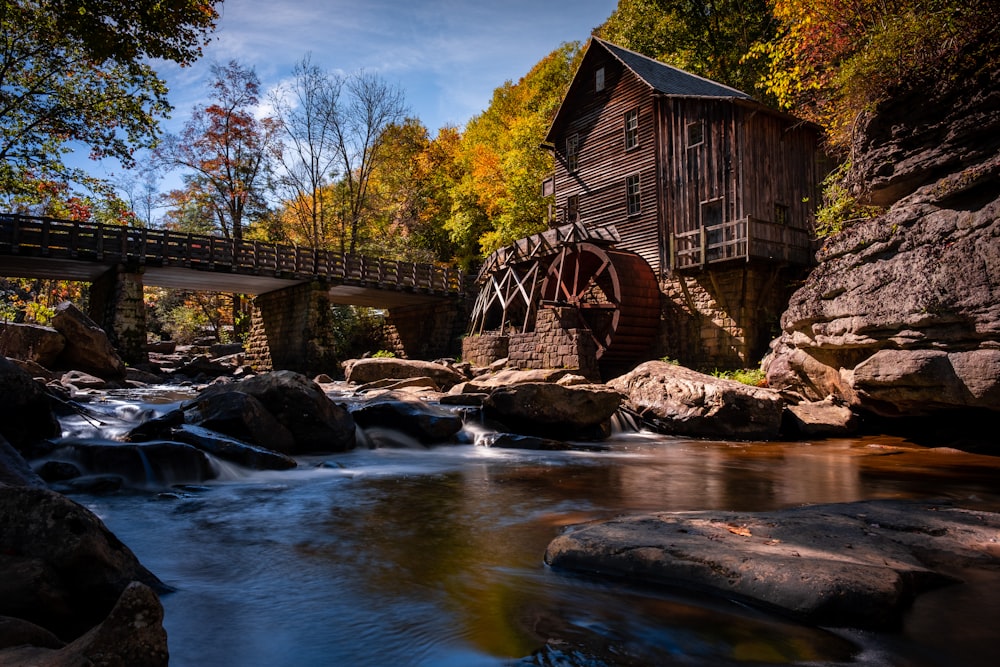 a river runs under a wooden bridge