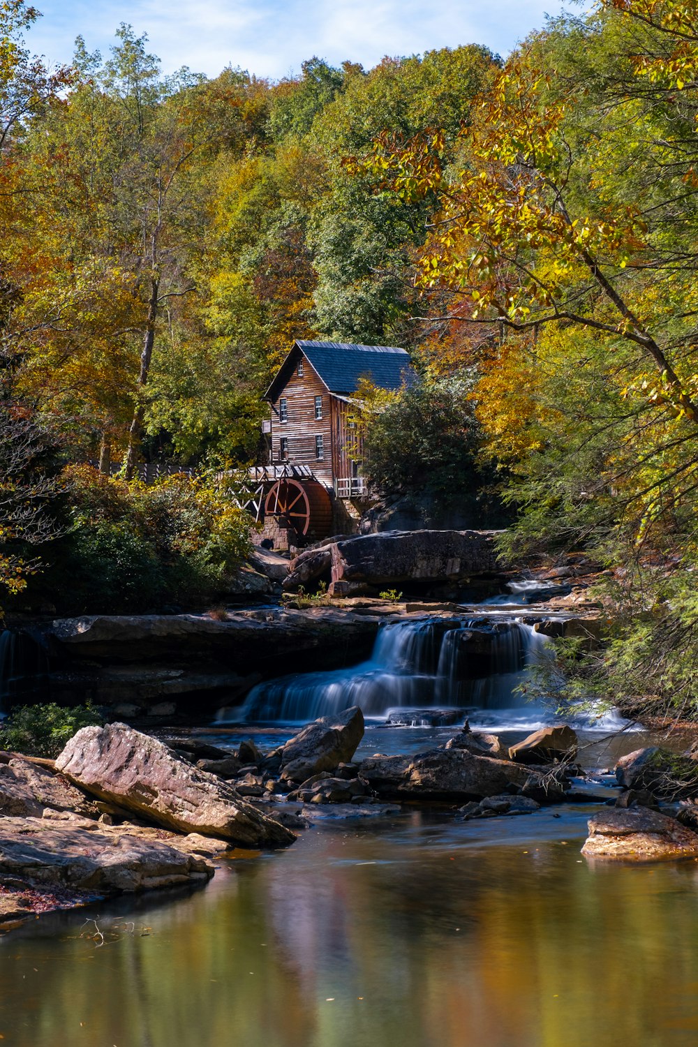 a small wooden building sitting on top of a river