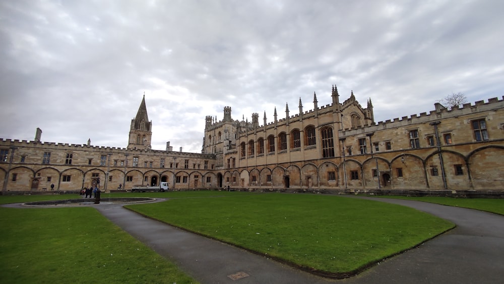 a large building with a green lawn in front of it