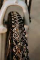 Close-up of a mountain bike tire gripping muddy terrain on a challenging trail.