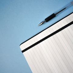 a pen sitting on top of a notebook