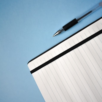 a pen sitting on top of a notebook
