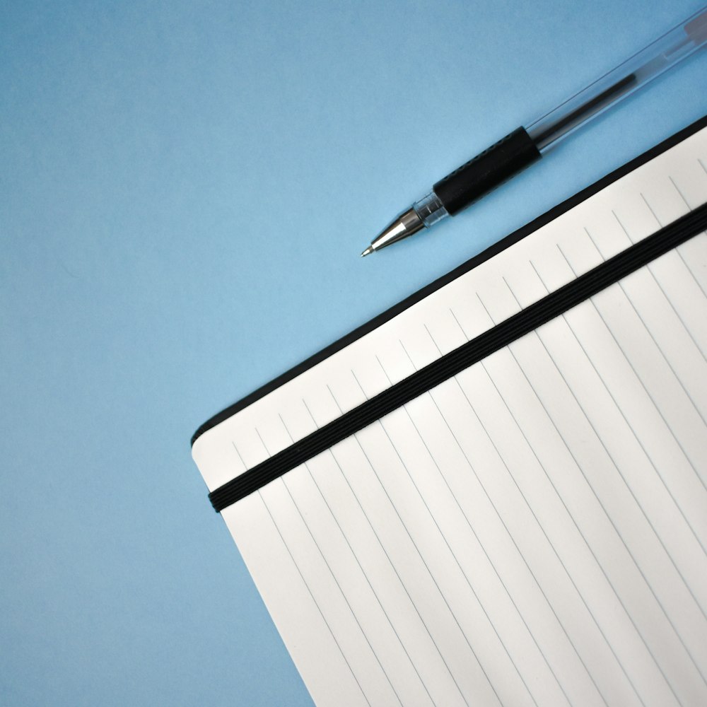 a pen sitting on top of a notebook