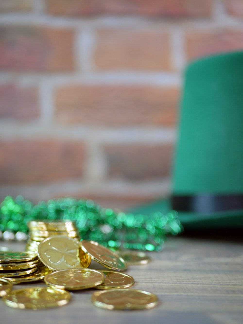 a green hat and some gold coins on a table