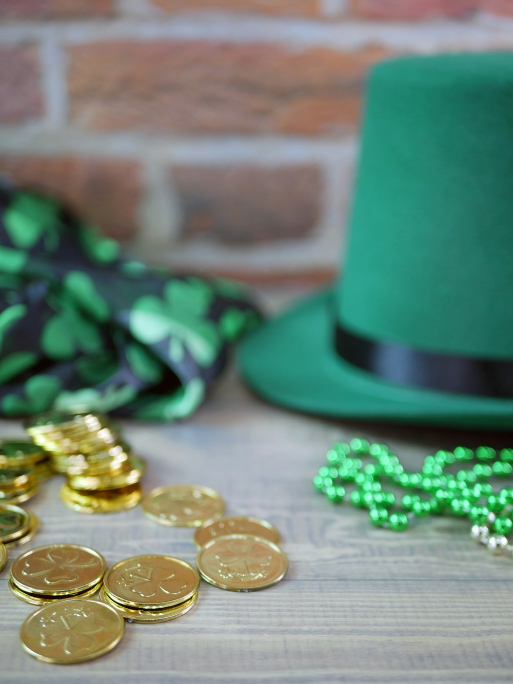 a green hat and some gold coins on a table