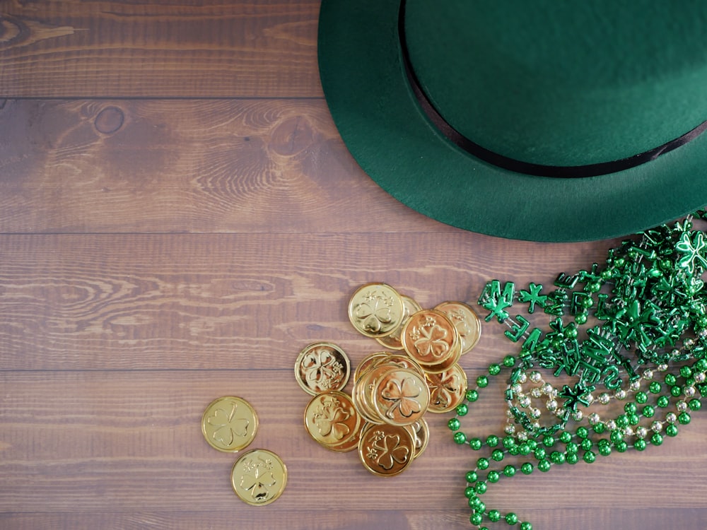 a green hat, beads, and a green hat on a wooden table