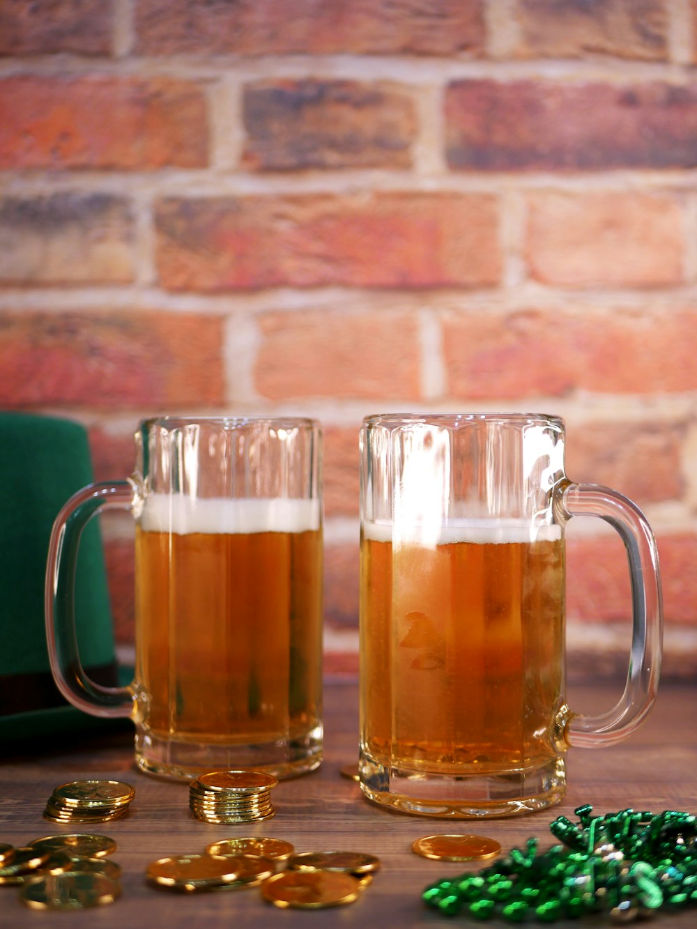 two mugs of beer sitting on a table