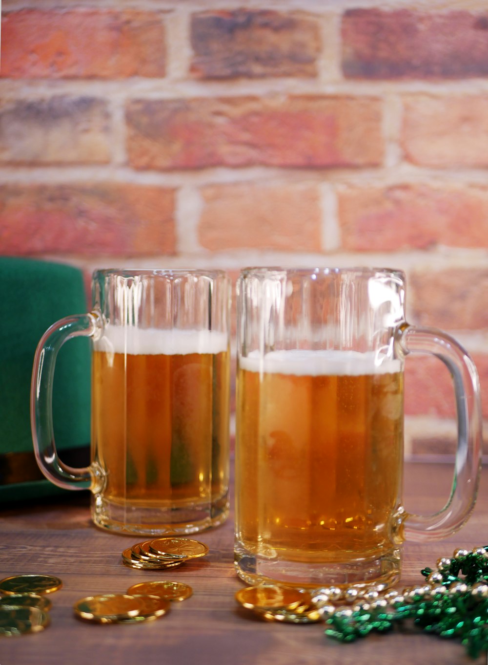 two mugs of beer sitting on top of a table