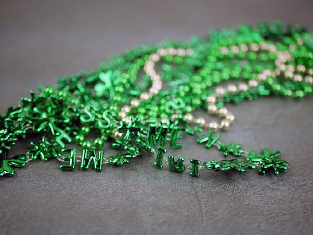 a bunch of green beads laying on top of a table