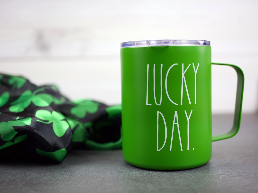 a green coffee mug sitting on top of a table