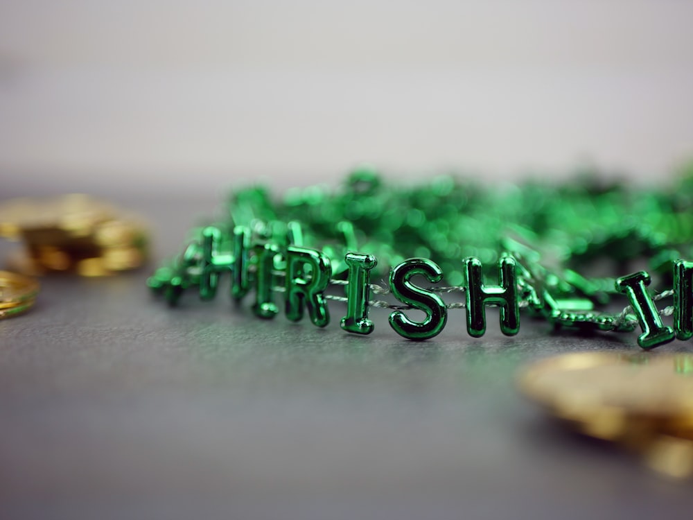 a pile of green plastic letters sitting on top of a table