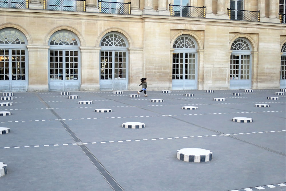 a person is walking through a large courtyard