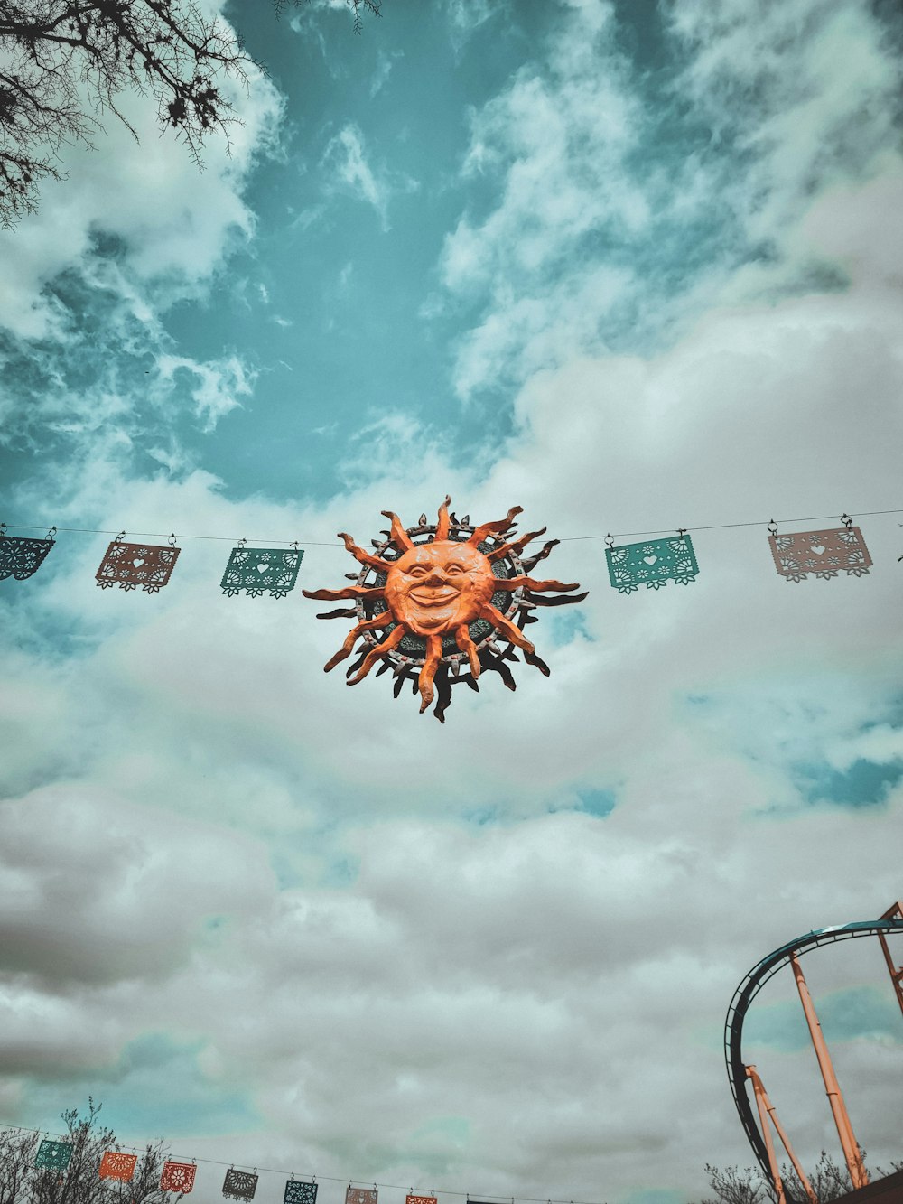 a large orange sun sitting on top of a metal pole