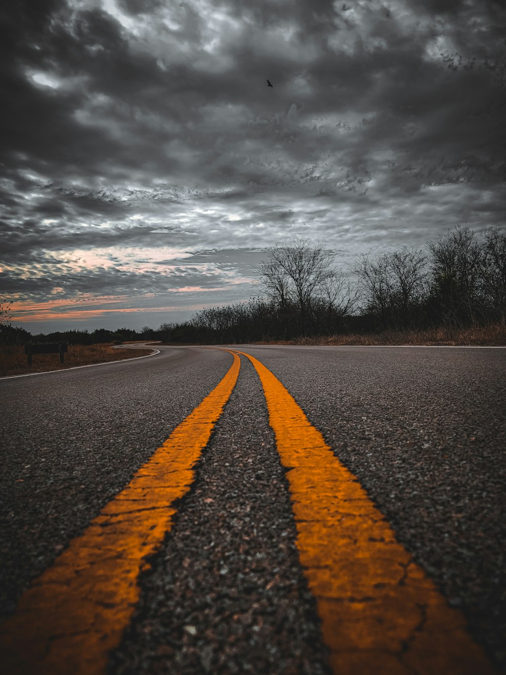 a road with two yellow lines painted on it