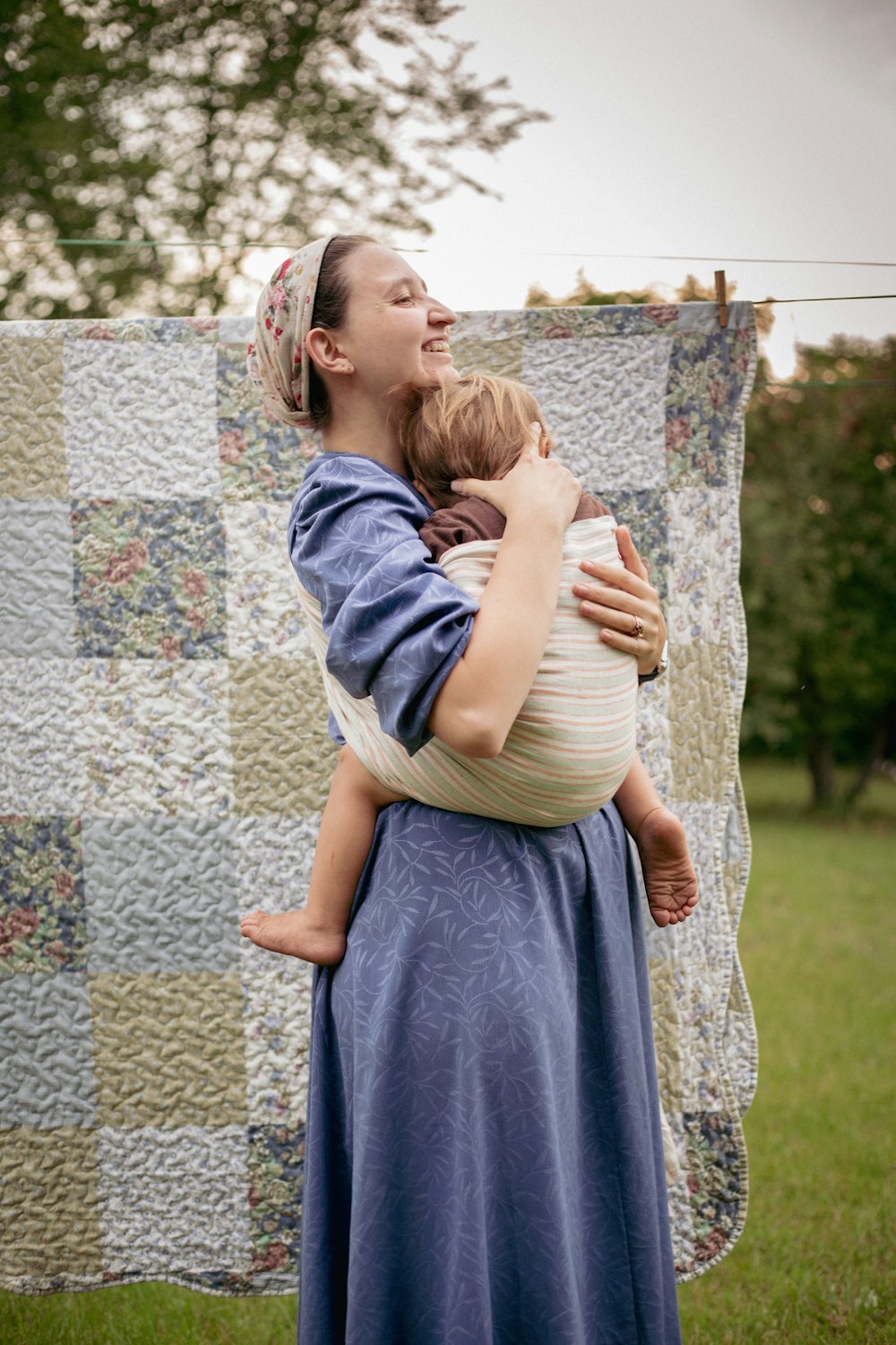 a woman holding a baby in her arms