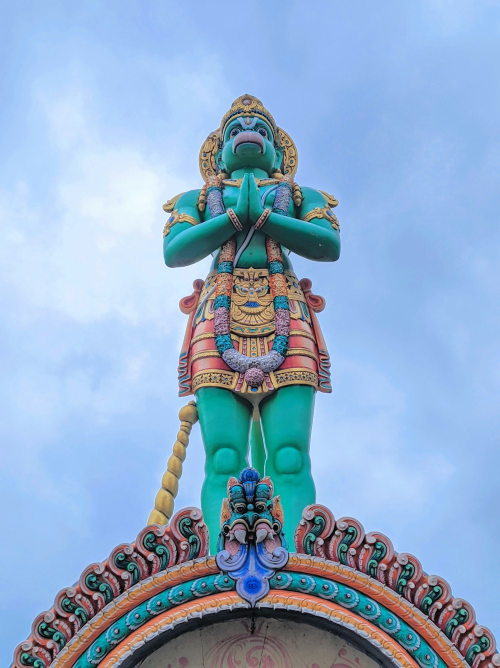 a statue on top of a clock tower