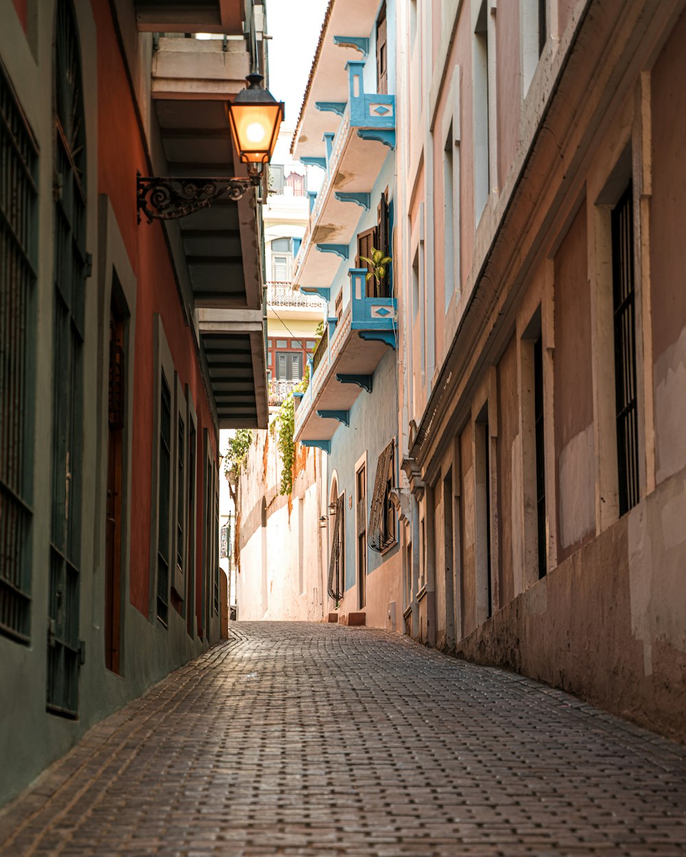 a cobblestone street lined with tall buildings