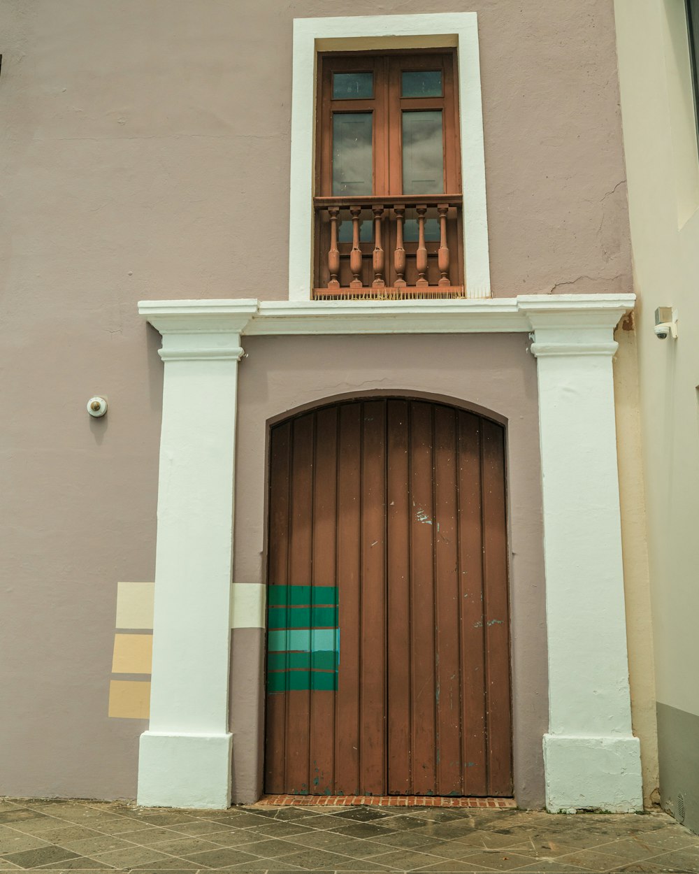 a brown and white building with a wooden door
