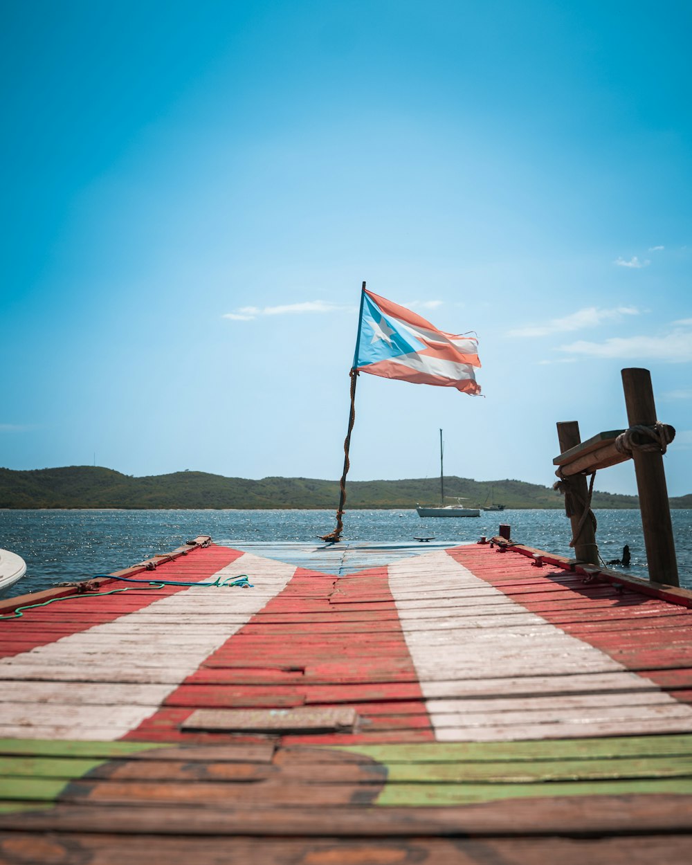 a wooden dock with a flag on top of it