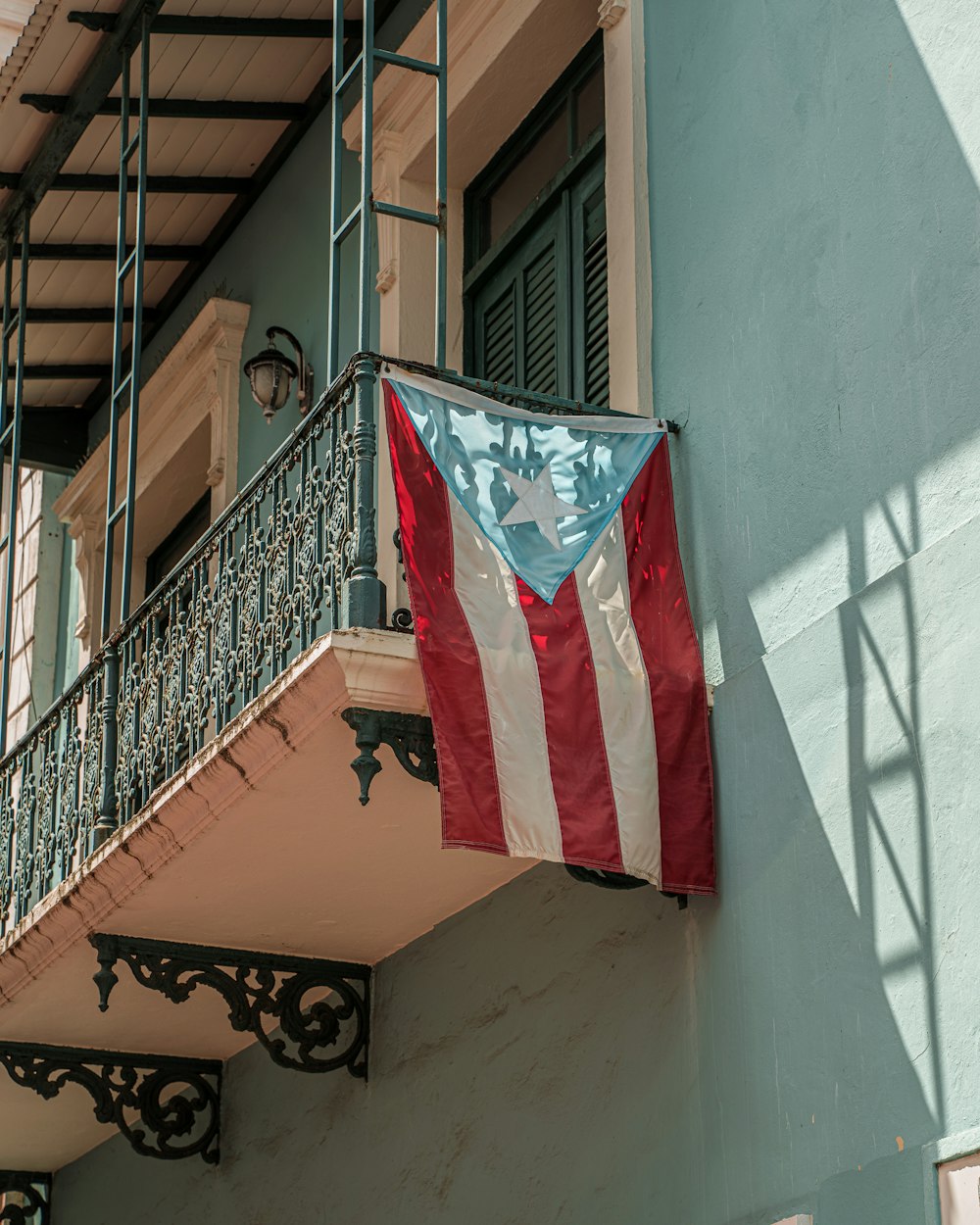 an american flag hanging from the side of a building