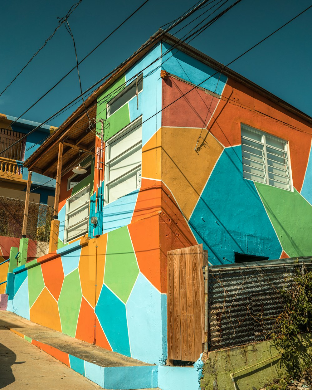 a multicolored building on a street corner
