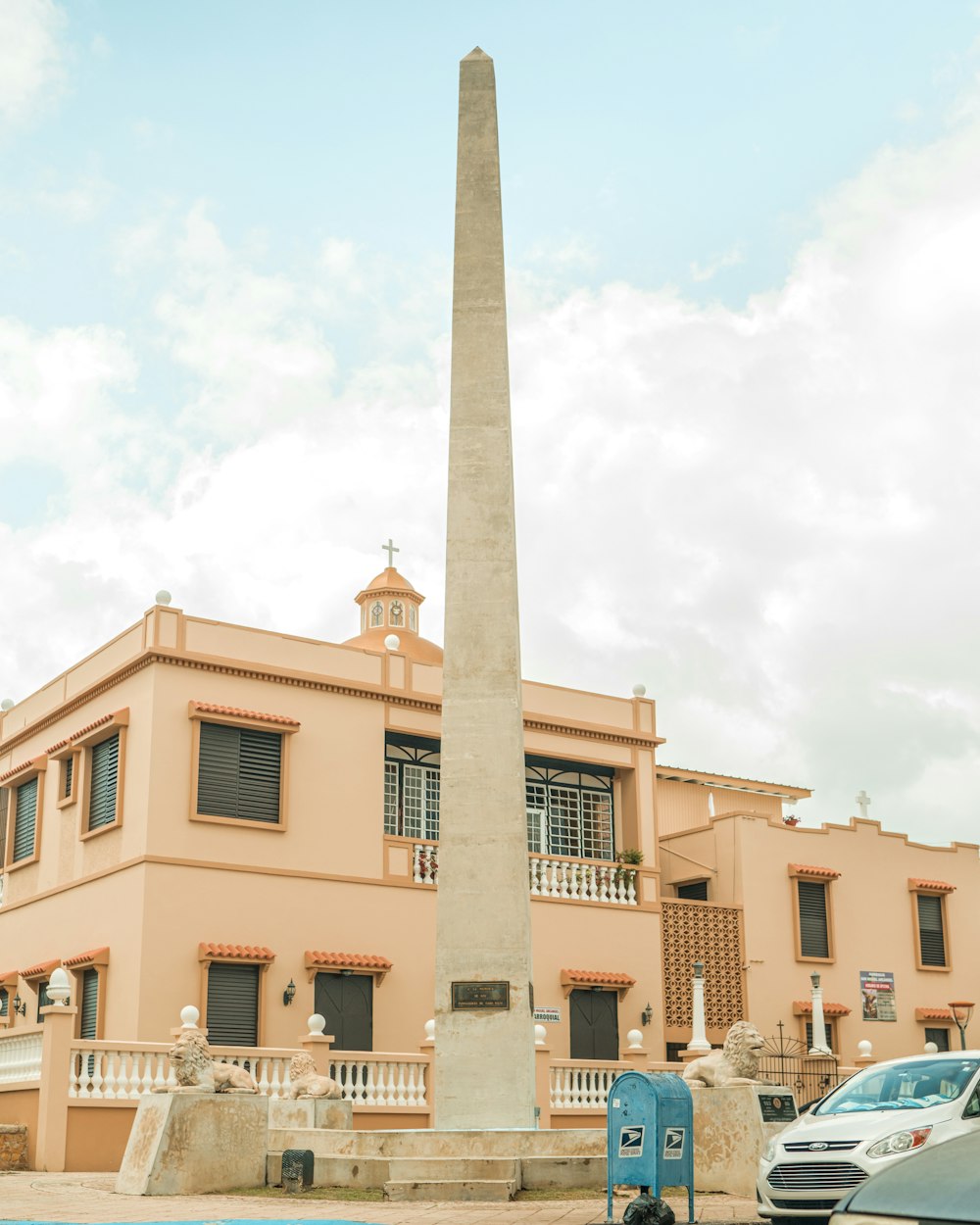 a tall obelisk in front of a building