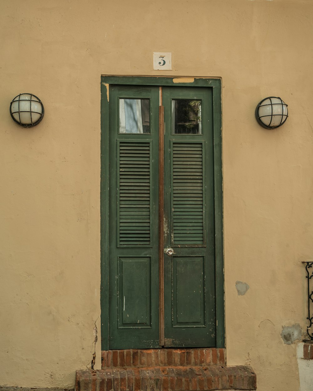 a green door with a number on it