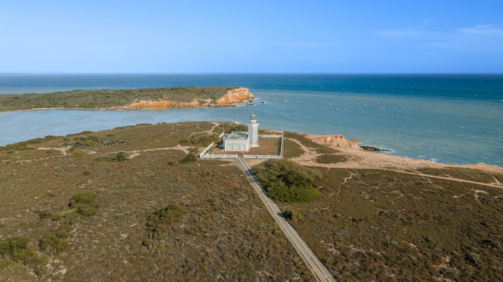 an aerial view of a lighthouse near the ocean