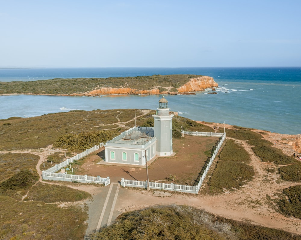 an aerial view of a lighthouse near the ocean