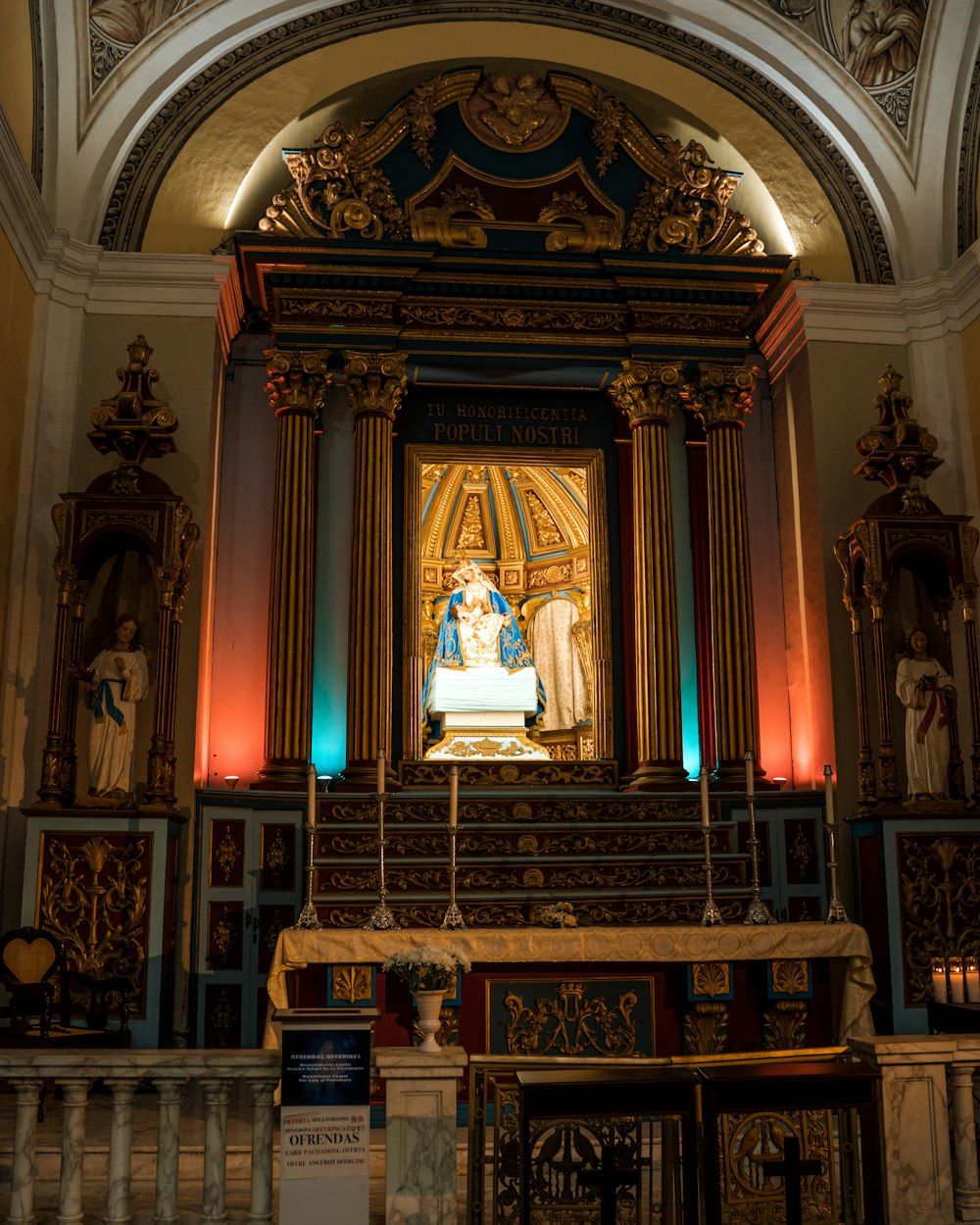 a church with a statue of a woman on the alter