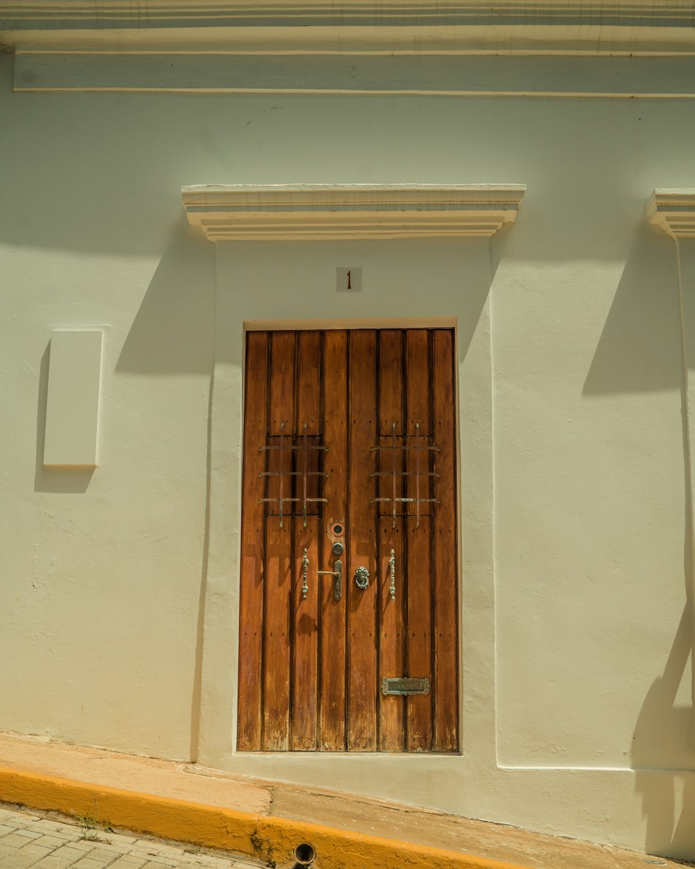 a white building with a wooden door and window