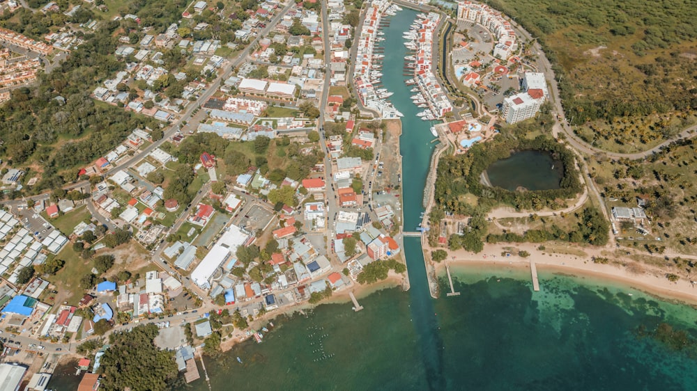 a bird's eye view of a small town next to a body of water