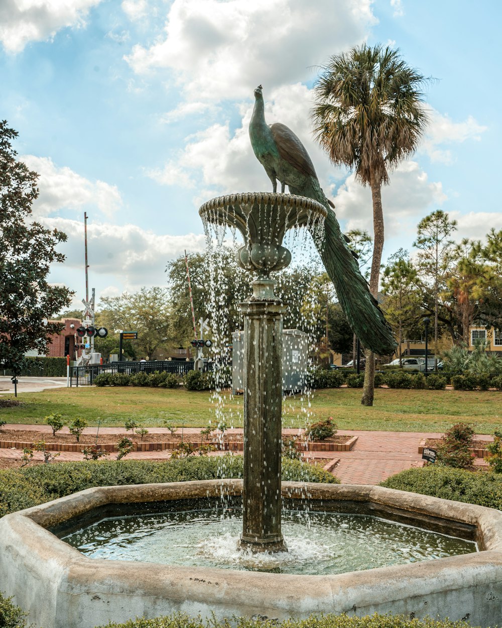 a fountain with a bird sitting on top of it