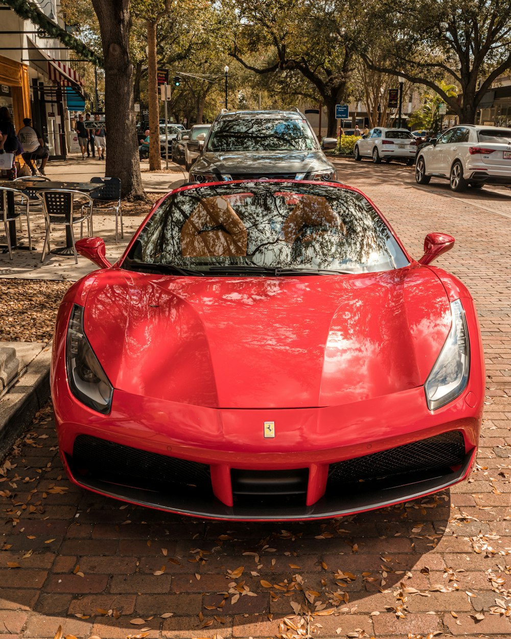 a red sports car parked on the side of the road