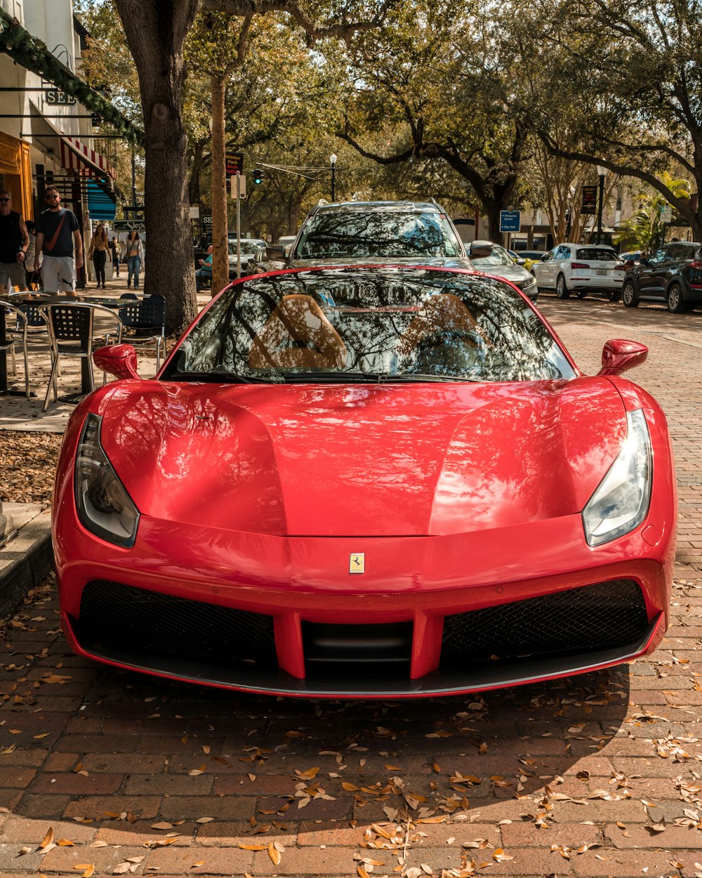 a red sports car parked on the side of the road