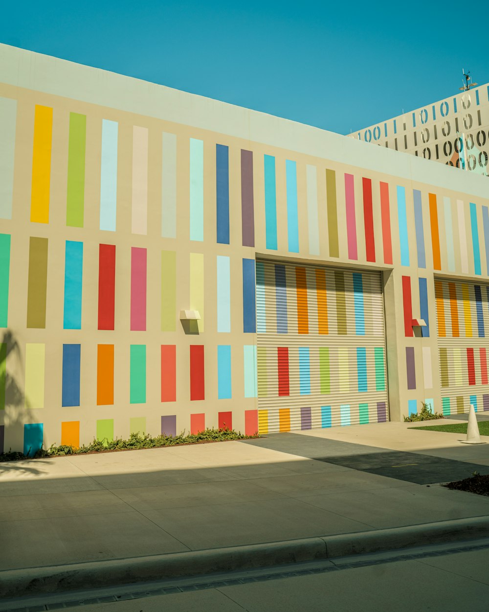 a multicolored building with a palm tree in front of it