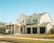 A modern renovated house exterior with fresh landscaping in a suburban neighborhood.