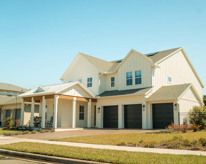 Large white two-story home with attached garages