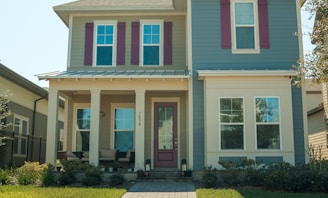 a blue and white house with red shutters