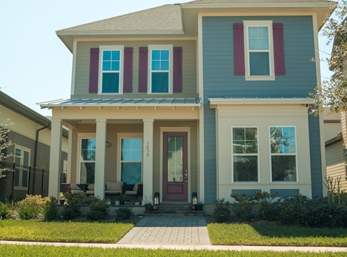 a blue and white house with red shutters