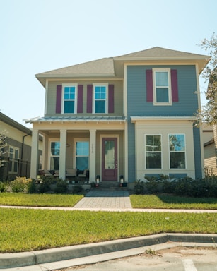 a blue and white house with red shutters