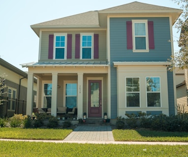 a blue and white house with red shutters