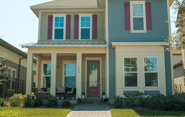 a blue and white house with red shutters