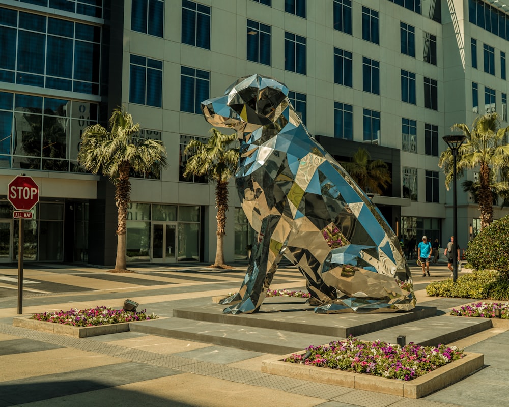 a sculpture of a dog sitting in front of a building