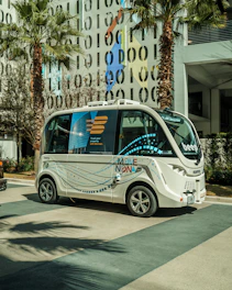 a small bus is parked in front of a building