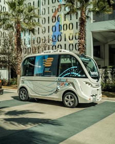 a small bus is parked in front of a building