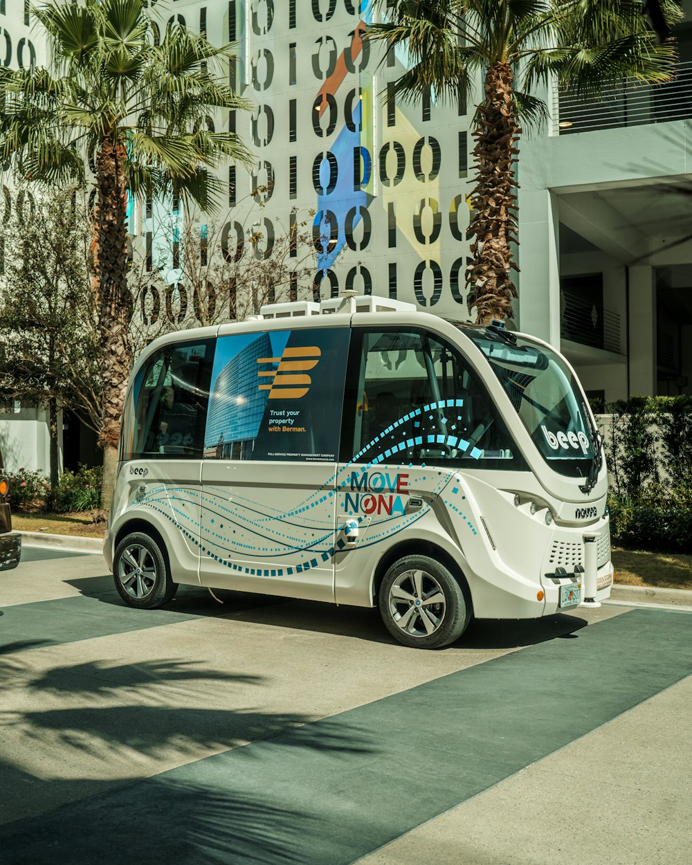 a small bus is parked in front of a building