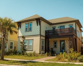 a two story house with a balcony and balconies