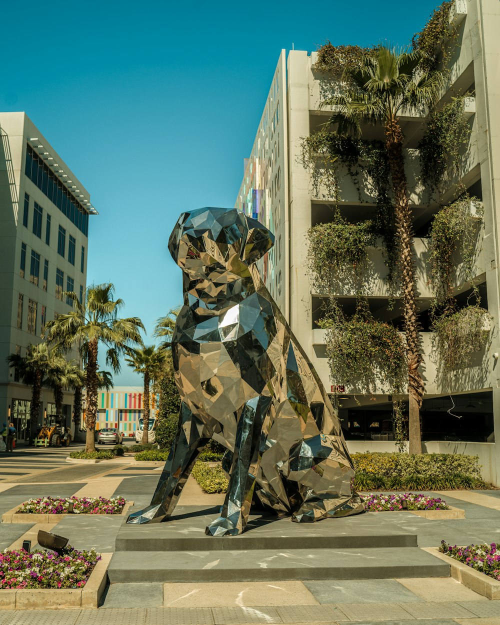 a statue of a dog sitting on top of a cement slab