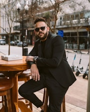 a man sitting at a table with a book